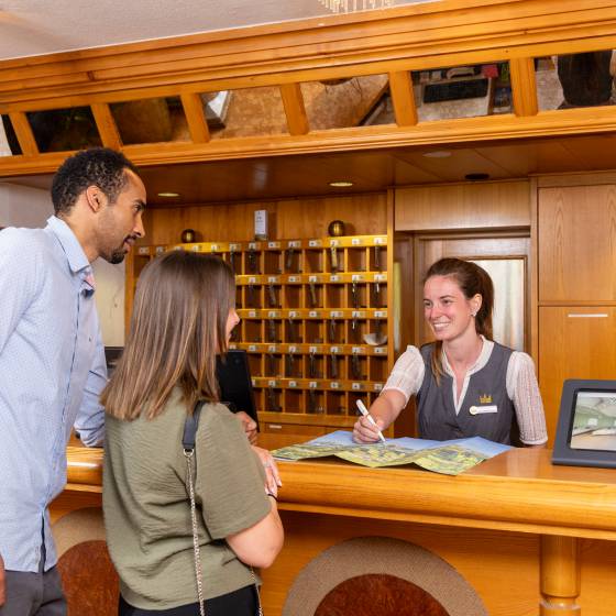 Paar checkt in der Rezeption des Hotel Königshof ein